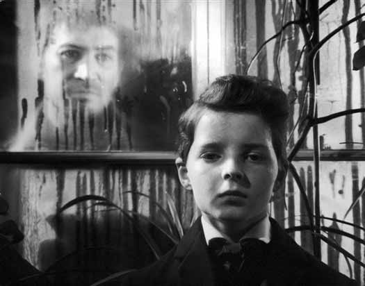 The ghost of Quint (Peter Wyngarde) oversees young Miles (Martin Stephens).