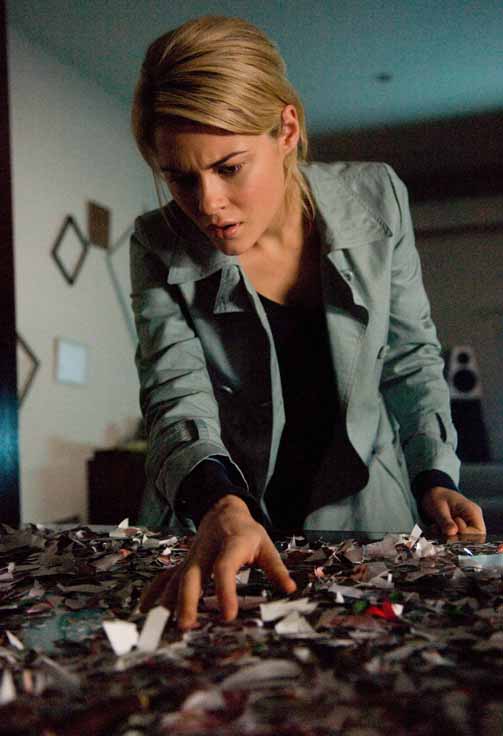 Jane (Rachel Taylor) discovers a clue to the haunting. 